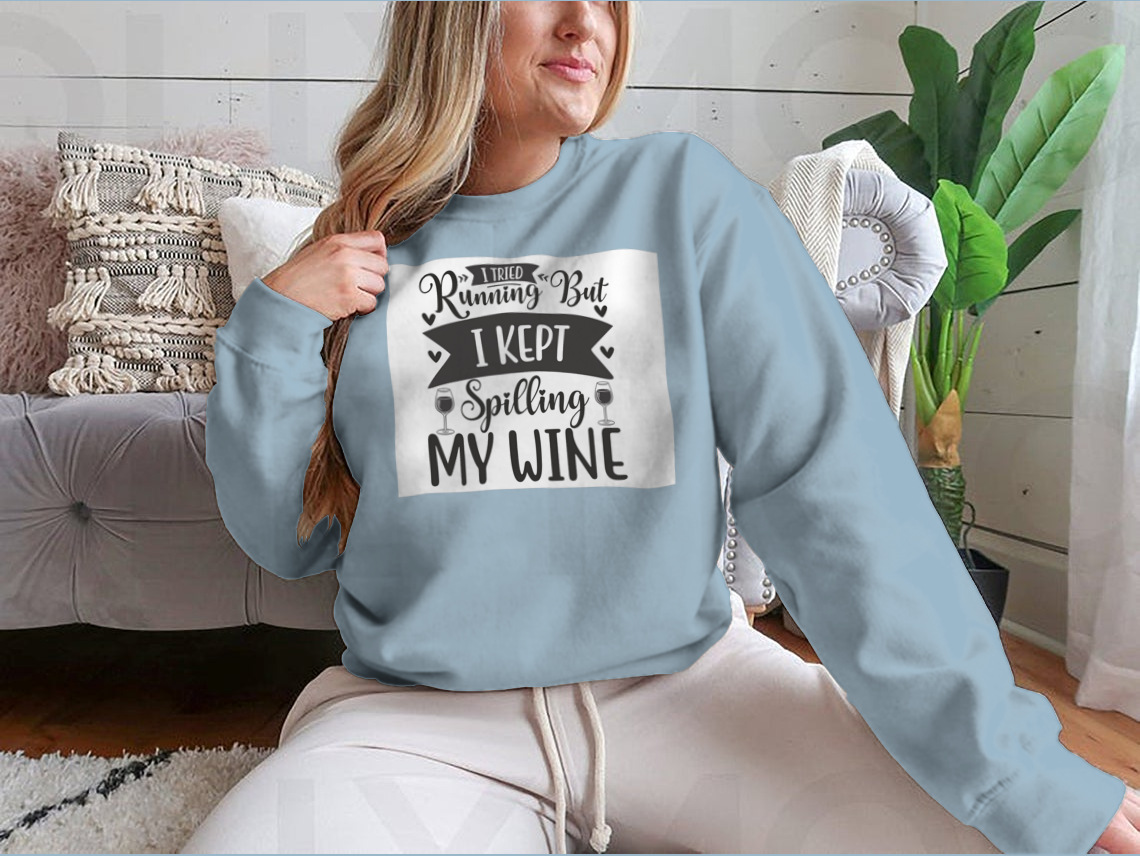 A cozy sweatshirt featuring the humorous phrase 'I Tried Running But I Kept Spilling My Wine', perfect for wine lovers.